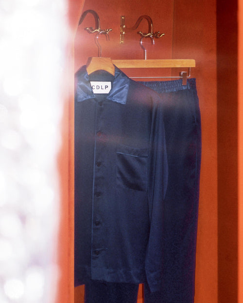 Navy Blue Home Shirt and Home Trousers hanging in a fitting room