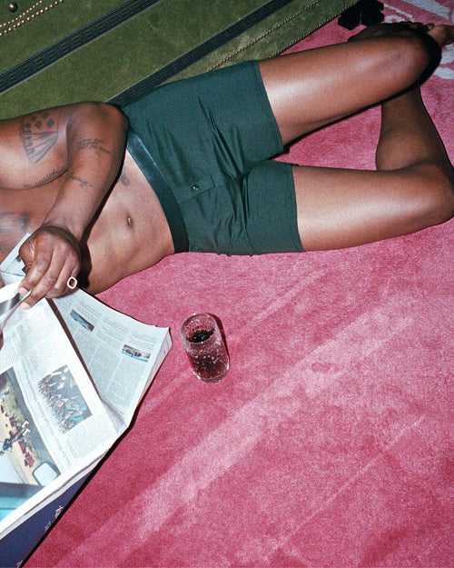 Marcus laying on the floor and reading the news wearing Boxer Shorts in Army Green