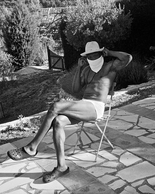 Marcus sitting outside in the sun wearing Lyocell Boxer Trunk in White