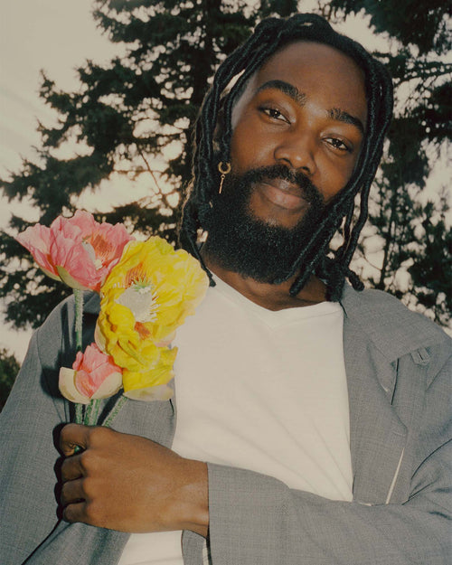 Brou holding flowers and Wearing a plain Lyocell V-Neck T-Shirt in White