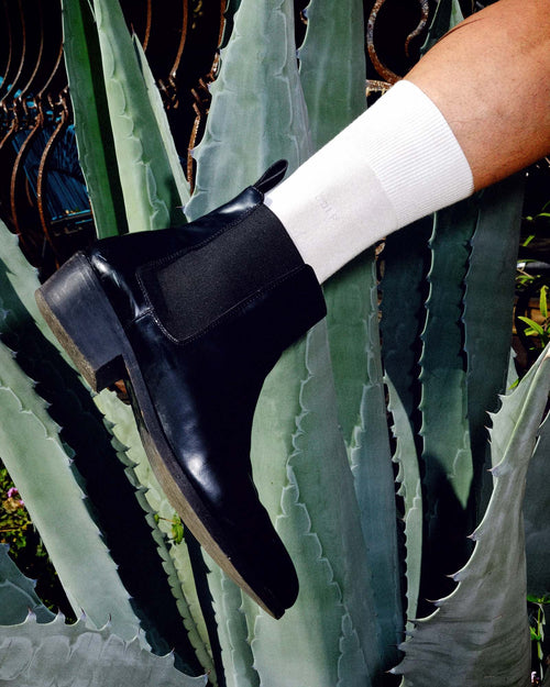 Oskar wearing boots and Mid-Length Socks in White