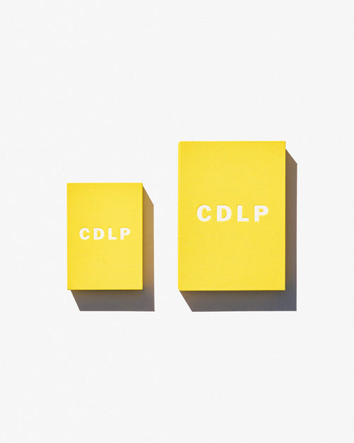 Small yellow signature box containing Mini Boxer Brief next to regular sized yellow box