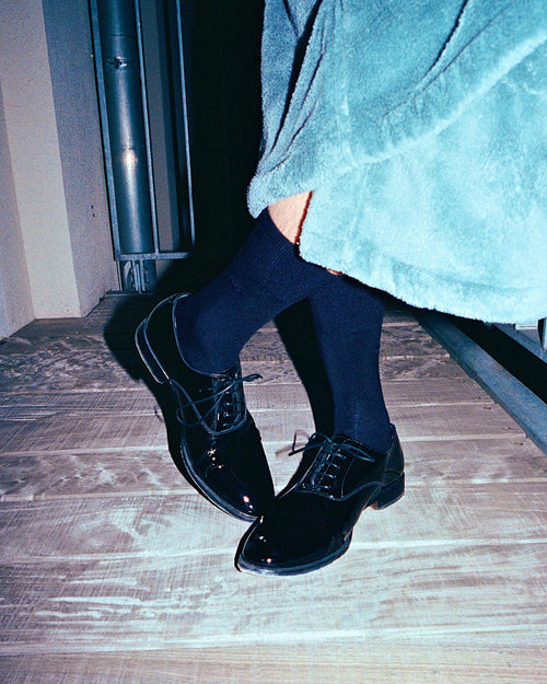 Oskar wearing black shoes and Mid-Length Socks in Navy Blue