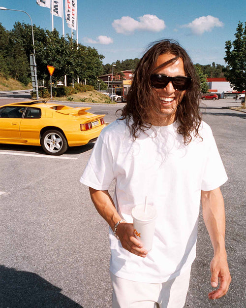 Oskar walking on the street in the sun Heavy Jersey T-Shirt in Optic White made from Recycled and Organic Cotton