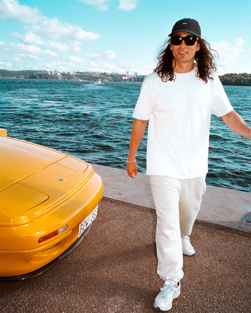 Oskar standing by the ocean wearing Heavy Jersey T-Shirt in Optic White