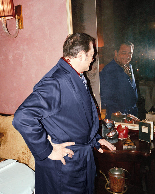 Giacomo looking in the mirror wearing Home Robe in Navy Blue