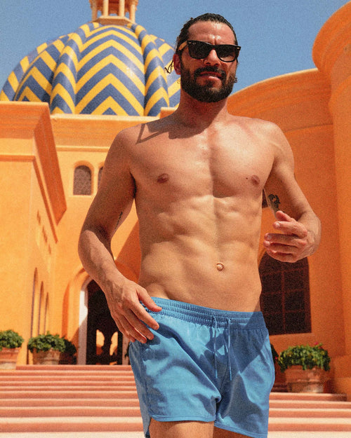 Uriel running wearing Swim Shorts in Maya Blue